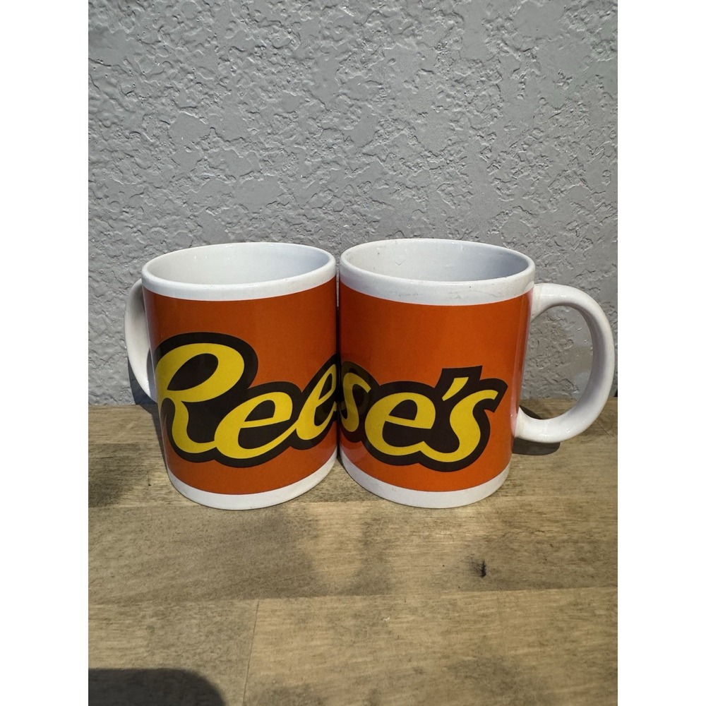 Reese's Set of 2 Galerie Orange Ceramic Coffee Mugs With Yellow Logo - Picture 1 of 2